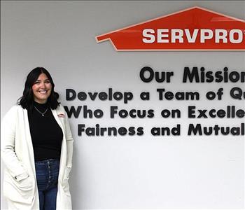 woman in front of mission statement