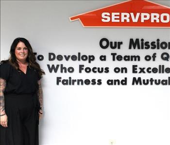 woman in front of mission statement