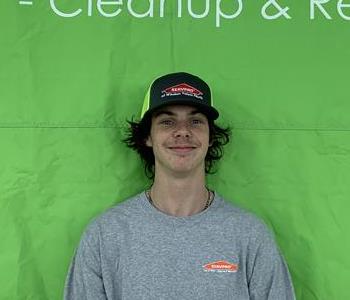 Rocco: Young man in grey shirt and SERVPRO cap 