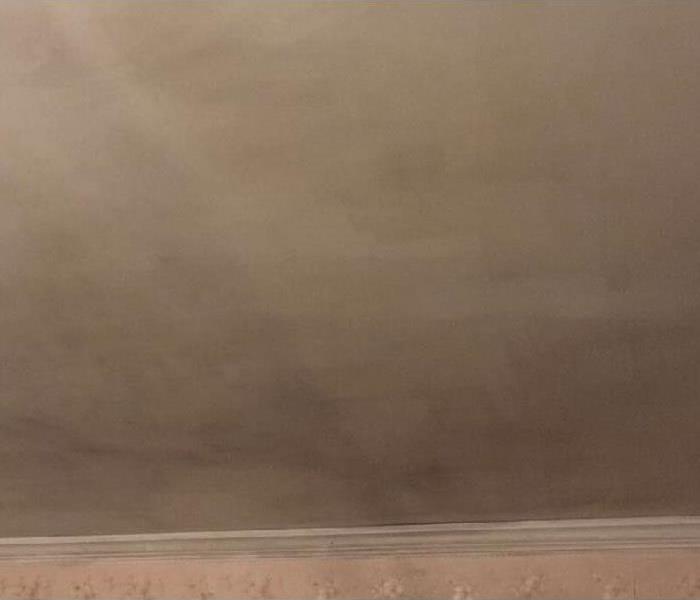 Dark soot coated a ceiling after a kitchen fire