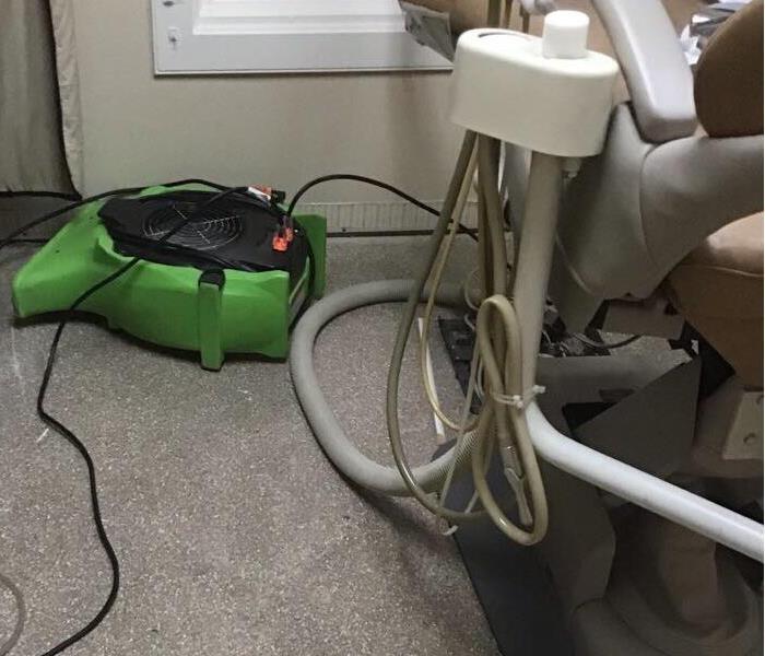 dentist office chair with water damage on floor