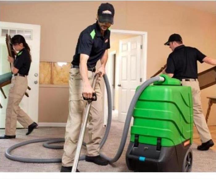 SERVPRO cleaning crew working on a carpet 