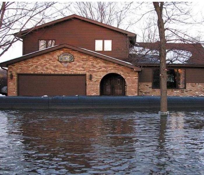 house surrounded by flood waters